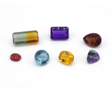 A mixed lot of faceted quartz, including two citrine, an amethyst, a mystic (coated) quartz, a citrine/prasiolite, a blue qua