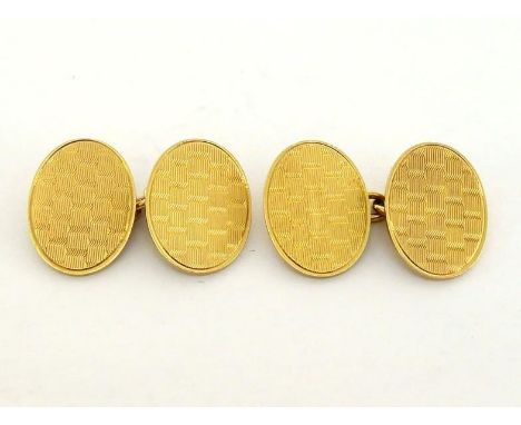 A pair of 18 carat gold cufflinks, the oval links with engine turned design, 17mm long, hallmarked verso, 11gms gross 