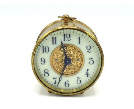 A  Swiss brass cased bedside alarm clock by Buren with bevelled glass, white chapter ring and fretted brass centre, the case 