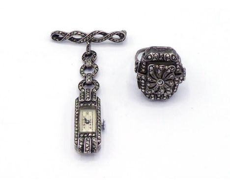 A mid 20th century marcasite set ring watch, opening at the bezel to reveal a silvered dial, with 15 jewel manual wind moveme