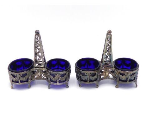 A pair of French silver double salts, Paris, 1784, the oval salts with openwork sides stamped with putti supporting ribbon-ti
