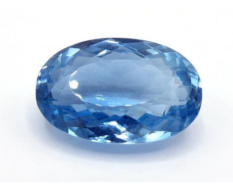A single oval cut blue topaz, 30.81 carats (VAT to be charged on the hammer of this lot) 