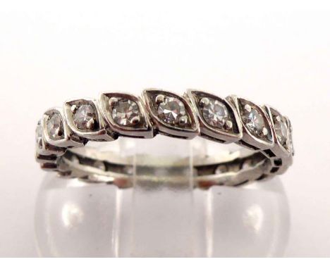 A diamond eternity ring, set overall with small single-cuts in segmented mount, mounted in white metal (tests 18 carat gold),