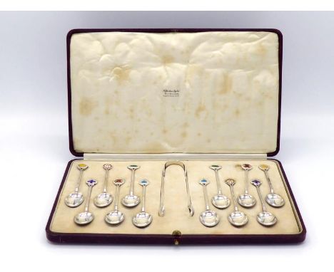 A very pretty set of twelve silver and enamel coffee spoons with sugar tongs en suite, in the Arts & Crafts manner, by James 