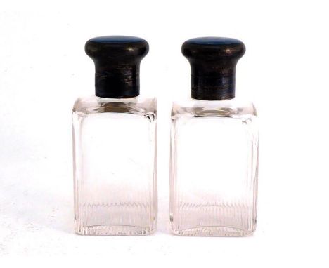 A pair of cut-glass scent bottles with greyish-blue guilloche enamel tops, by Collett & Anderson, London, 1932, the upright r