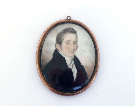 English School, early 19th century. A portrait miniature of a gentleman, his brown hair brushed forward, wearing black coat a