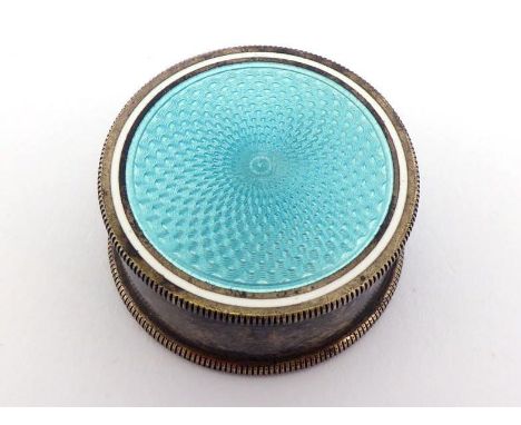 A silver-gilt and light blue guilloche enamel pill box with aperture at side, possibly adapted to hold a pencil sharpener(?) 
