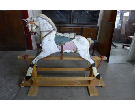 A vintage dapple grey rocking horse