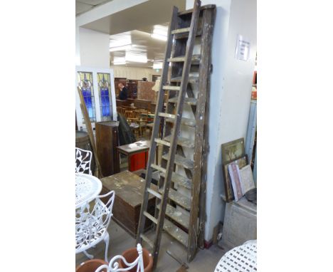 A set of pine stepladders and another ladder