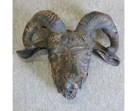 A painted metal model of a rams head, 37cm tall