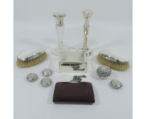 An early 20th century silver mounted leather wallet, together with a silver candlestick, 19cm  tall, another, a table cigaret