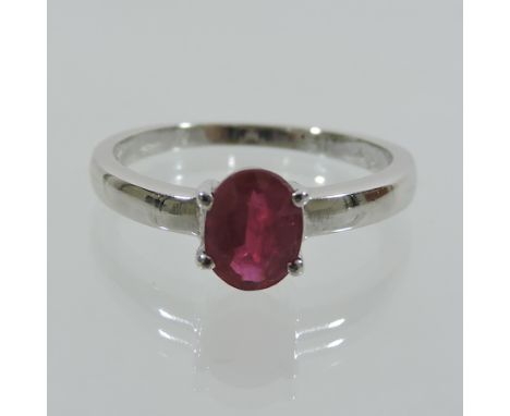 An 18 carat white gold and ruby single stone ring, by Kojis, boxed