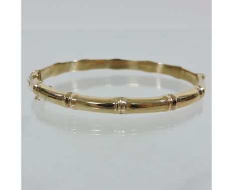 A 9 carat gold hinged bangle, of bamboo design