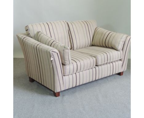 An as new Marks and Spencer's cream and striped upholstered two seater sofa, 170cm