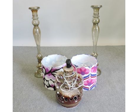 A pair of glass candlesticks, 90cm tall, together with a pair of 70's style lamp shades and a lamp