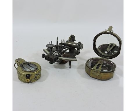 A Brunton compass, together with a sextant and a marching compass