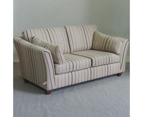 An as new Marks and Spencer's cream and striped upholstered two seater sofa, 185cm