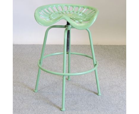 A green painted tractor seat bar stool