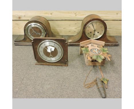 A 1930's oak mantel clock, together with two others and a cuckoo clock, 25cm tall