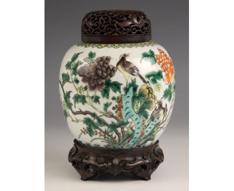 A Chinese porcelain famille vert ginger jar, cover, and stand, 19th century, the ovoid ginger jar decorated in the Kangxi man