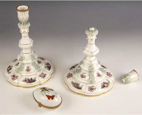A pair of KPM Berlin porcelain candlesticks, 20th century, the urn shaped sconce leading to a stepped, spreading circular bas