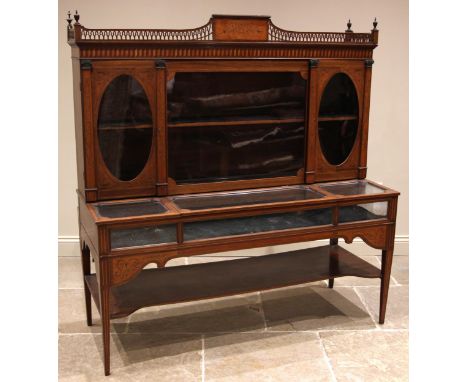 An Edwardian mahogany Sheraton revival bijouterie display cabinet, the three quarter open fretwork gallery centered with a fo