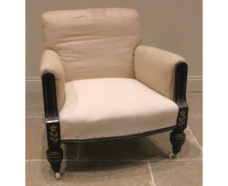 A Victorian Aesthetic Movement armchair, the padded arms enclosing a gently bowed sprung seat, flanked by the reeded ebonised