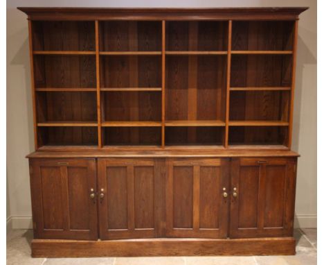 An early 20th century large oak specimen display cabinet/bookcase, originally from Exeter museum, the moulded cornice over fo