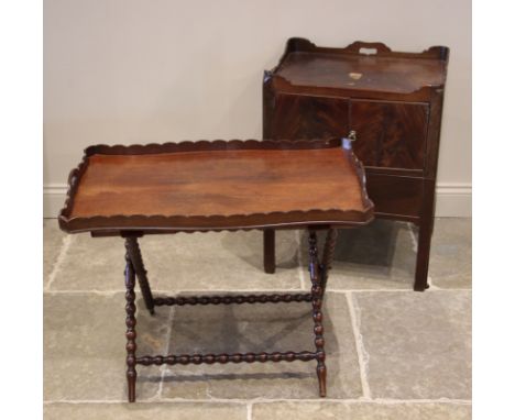 A George III mahogany tray top bedside chest, the galleried top over a pair of cupboard doors and a sliding drawer upon integ