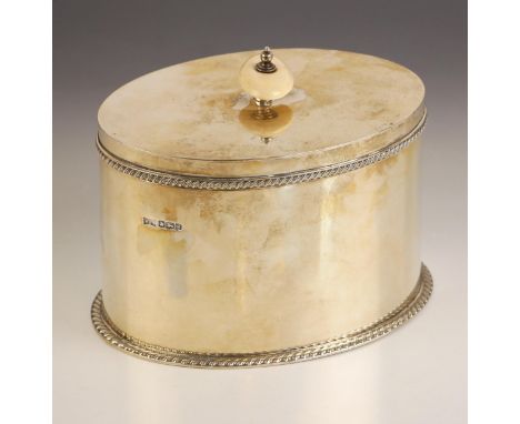 A George V silver tea caddy, Walker and Hall, Sheffield 1924, the ivory finial above hinged cover with gadrooned border, with