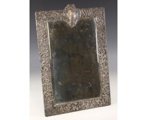 A large Victorian silver mounted easel mirror, Goldsmiths and Silversmiths, London 1899, the rectangular mirror with scrollin
