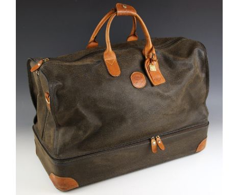 A Brics holdall type travel bag, the textured black leather body with tan leather handles and corner reinforcers, shoe compar