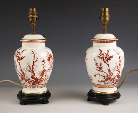 A pair of Indian tree pattern Imari lamp bases, possibly Spode, each of covered baluster vase form, with hardwood stands, lac