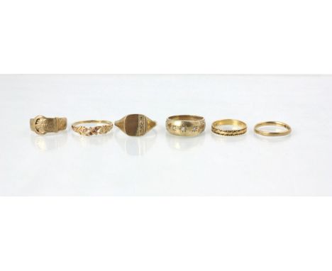 A group of six yellow metal rings, including a 9ct yellow gold signet ring, a 9ct yellow gold Victorian style ‘buckle’ ring, 