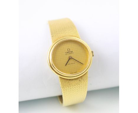 An 18ct yellow gold Omega DeVille ladies wristwatch, the textured gold oval face set to plain polished case, upon integral ta
