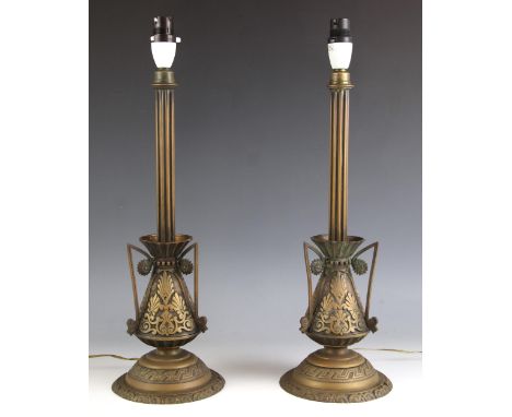 A pair of brass table lamp bases, 20th century, each with fluted column stem set to a conical body with geometric adornments 
