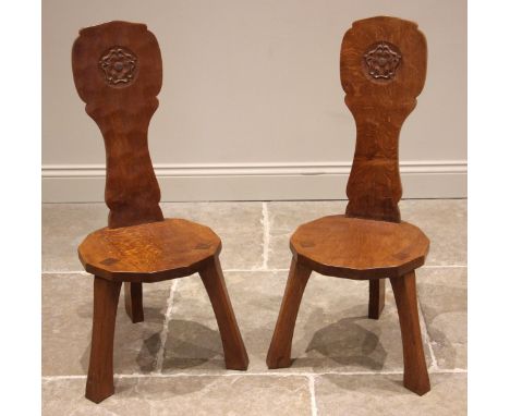 Thomas 'Gnomeman' Whittaker of Littlebeck, a pair of adzed oak spinning chairs, mid 20th century, the high backs centred with