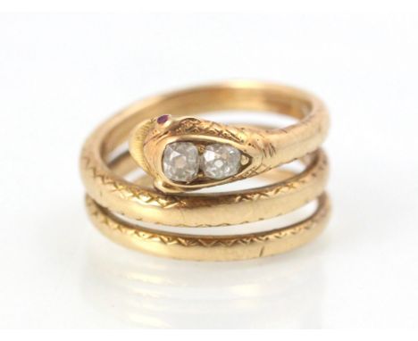 A 19th century yellow metal and diamond snake ring, the head of the snake set with two graduated old cut diamonds and red sto
