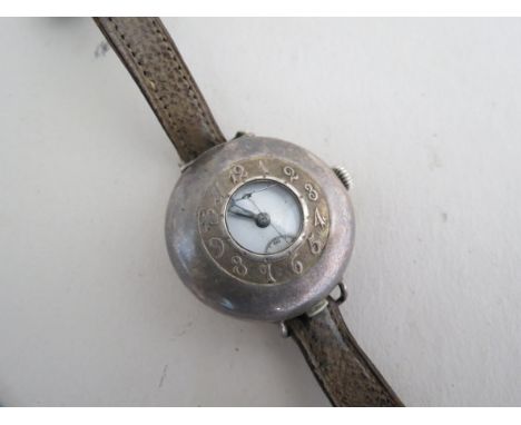 An early 20th Century Brevet 71363 silver wristwatch, outer case embossed with Arabic enamel dial with subsidiary seconds a/f