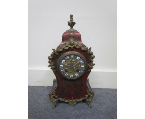 A 19th Century French boulle work mantel clock with ormolu finials, mounts,porcelain cartouche chapter ring with Roman numera