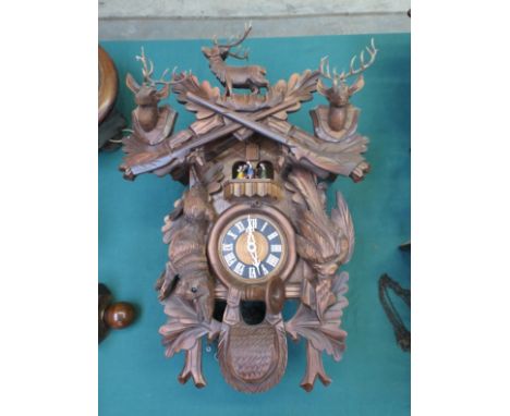 A 20th Century Black Forest cuckoo clock with automaton dancing couples, weights and pendulum 