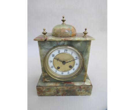 An onyx mantel clock, Arabic chapter ring with 8 day movement 
and brass finials 