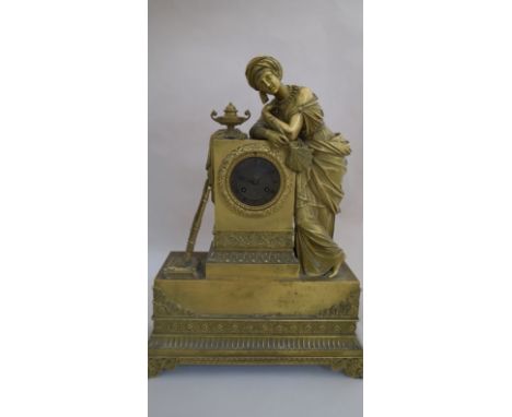 A 19th Century figural French mantel clock, surmounted by a maiden in Arabic clothing, harp and urn, Roman brass dial, eight 