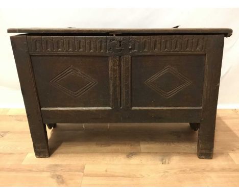 17th Century oak coffer, of small proportions, the hinged plank top with chip carved edge enclosing interior with candle box,