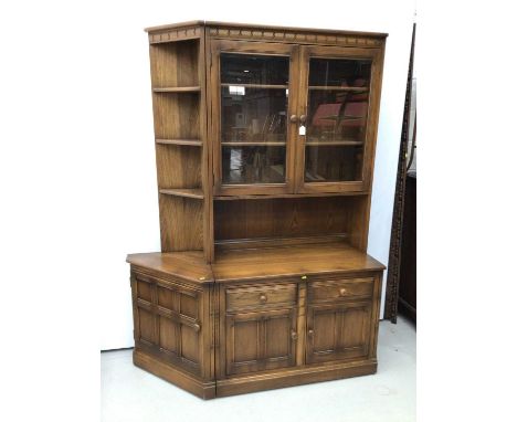 Ercol lounge unit to include two height bookcase with glazed doors above enclosing two adjustable shelves with two drawers an