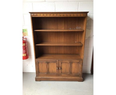 Ercol elm open bookcase with panelled doors below, 101cm wide, 30.5cm deep, 138cm high