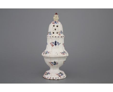 A Brussels faience caster, decor "A l'haie fleurie", 18th C. The finial restored, a reglued break. H: 18 cm