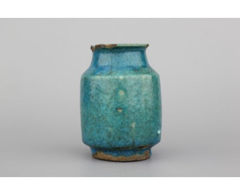 A turquoise glazed albarello, probably Kashan, 13th C. H: 13,5 cm. Chips to the top rim, glaze slightly deteriorated. Otherwi