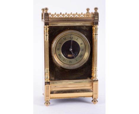A Victorian brass cased mantle clock, with gong strike of architectural form, the dial indistinctly marked Manchester with pe
