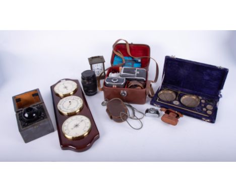 A mixed collection including three dial barometer set, cased scales and weights, Cyma carriage clock, a Canon 35mm camera len